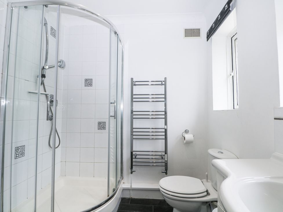 A bathroom with shower, toilet, and sink at Sea Dreams in Goring-By-Sea