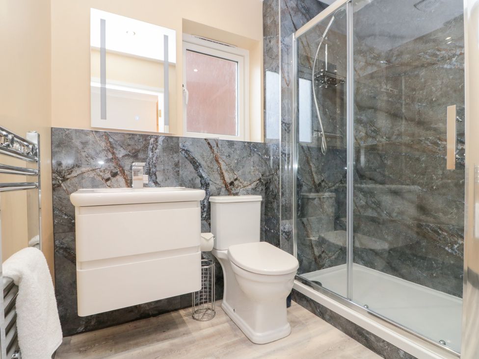 A bathroom with a sink, toilet, and shower at Quayside Haven in Whitby