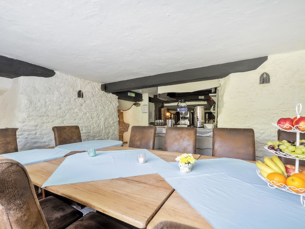 A dining room with a table and chairs at The Old Church House in Torbryan