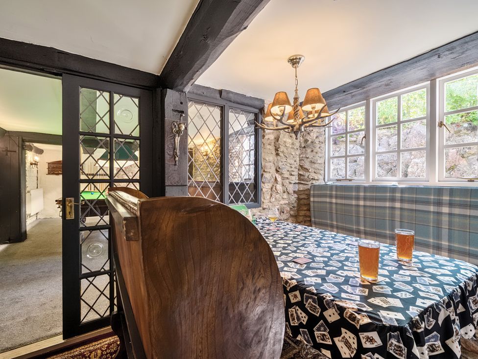 A dining room with a table and chairs at The Old Church House in Torbryan