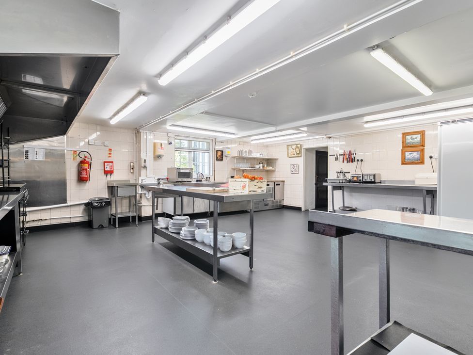 A kitchen with cooking equipment and utensils at The Old Church House in Torbryan