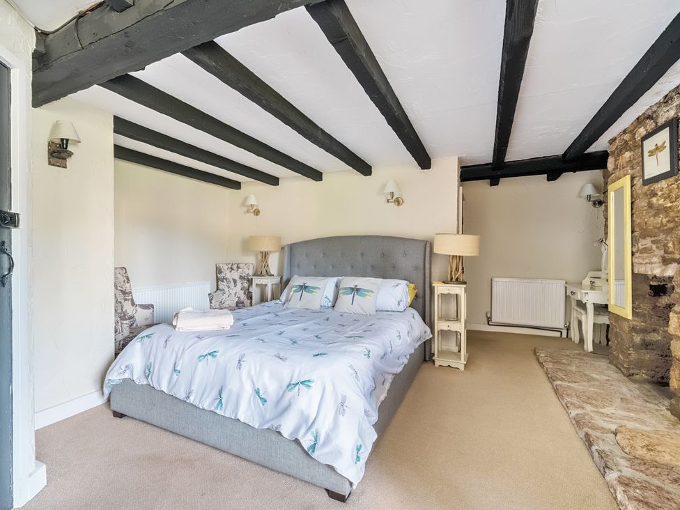 A bedroom with a bed and bedside tables at The Old Church House in Torbryan