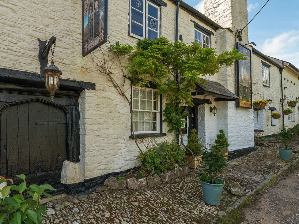 An outdoor view of a building with a door, windows and plants at The Old Church House in Torbryan
