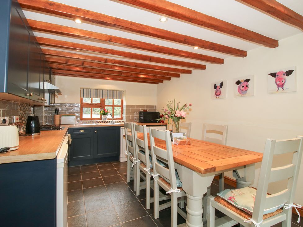 A kitchen with a table and chairs at Old Hall Barn 3 Church Stretton