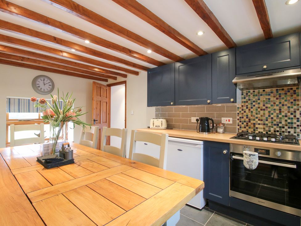 A kitchen with a table and chairs at Old Hall Barn 3 Church Stretton
