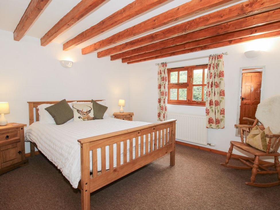 A bedroom with a bed and bedside table at Old Hall Barn 3 Church Stretton