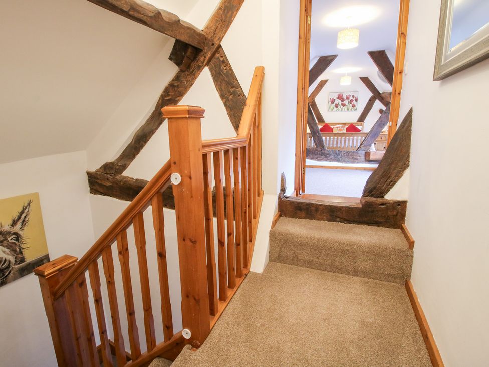 A staircase leading to a hallway at Old Hall Barn 3 in Church Stretton