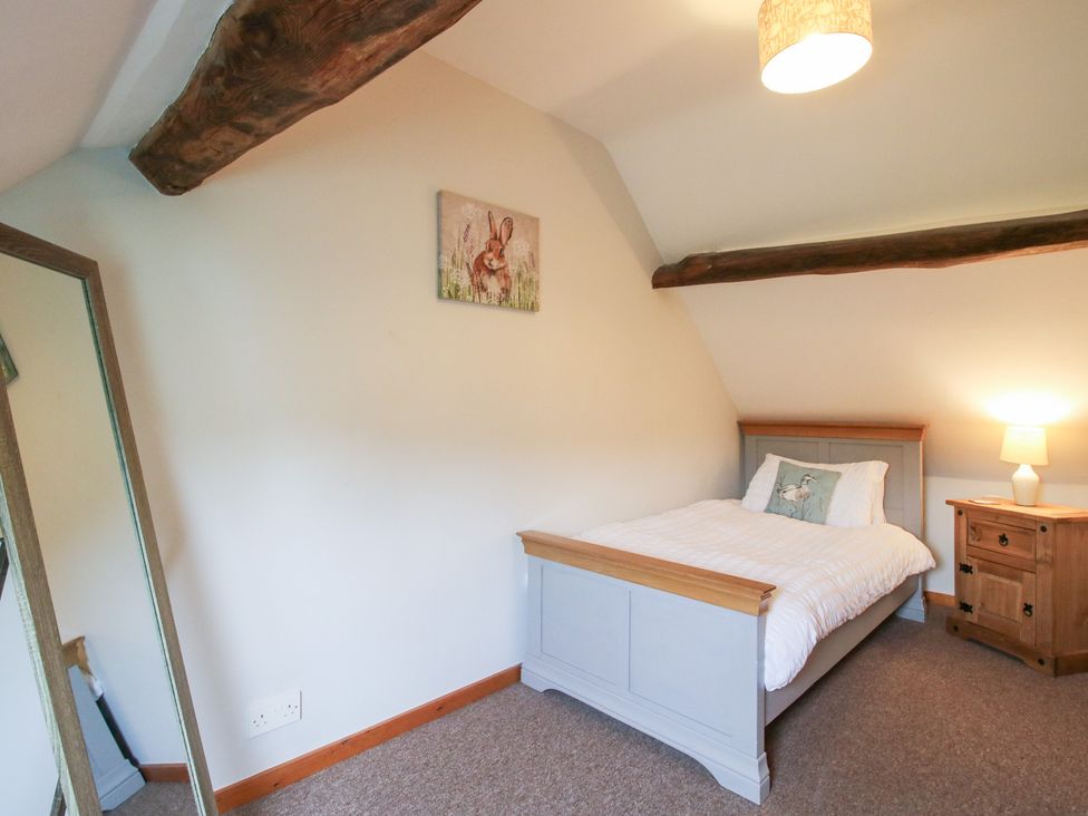 A bedroom with a single bed and chest of drawers at Old Hall Barn 3 Church Stretton
