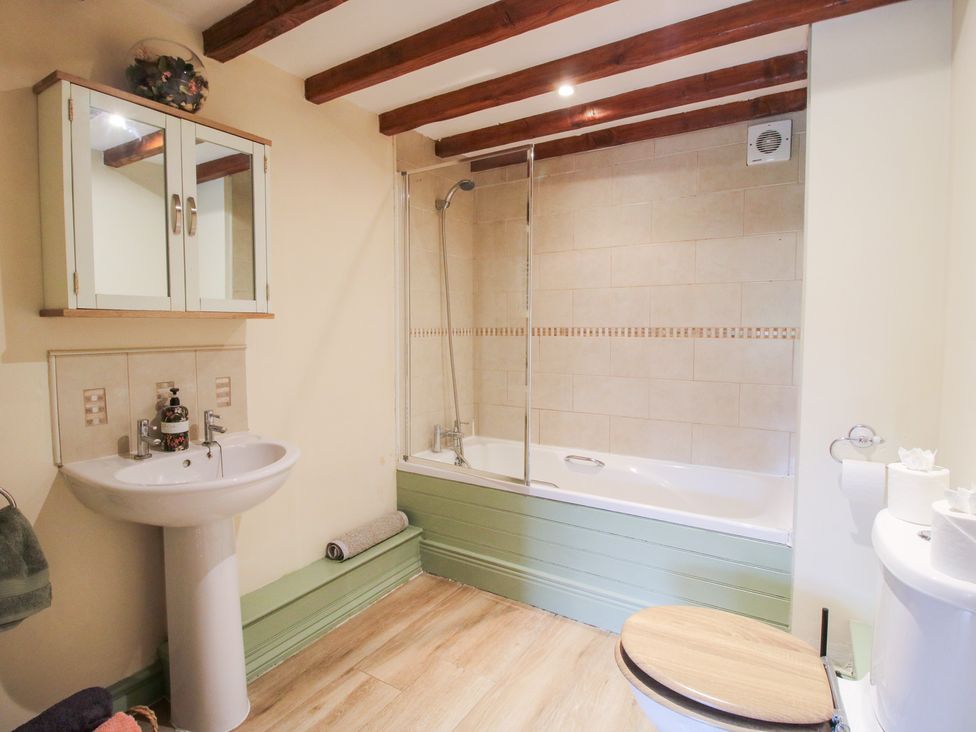 A bathroom with a sink, toilet, and bathtub at Old Hall Barn 3 Church Stretton