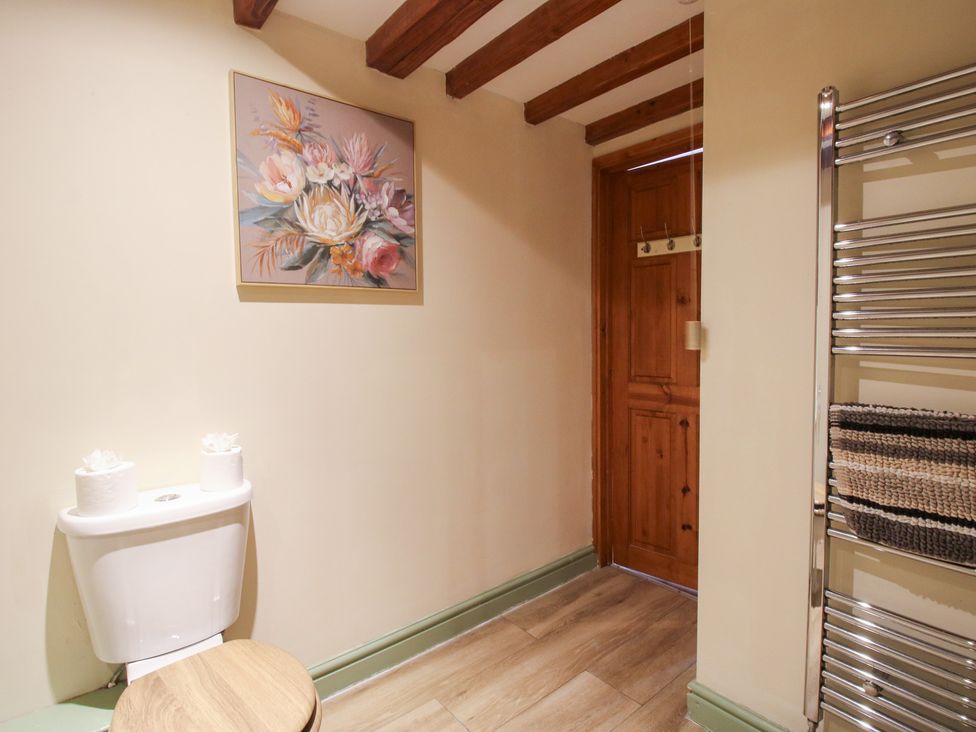 A bathroom with a toilet and towel rail at Old Hall Barn 3, Church Stretton