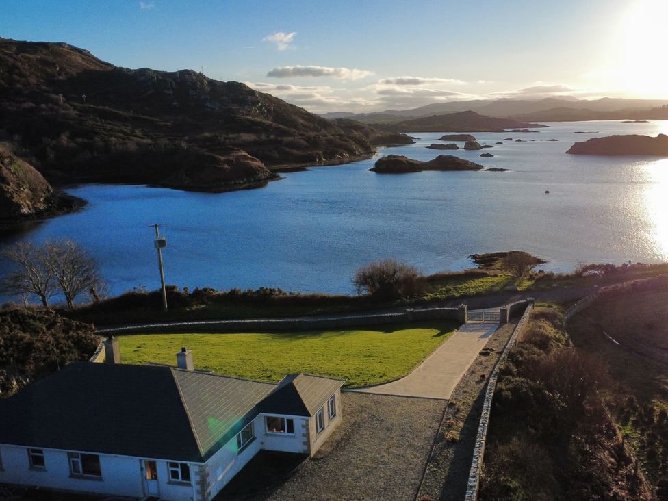 A house with a driveway and gate near water at Ranny Roe in Portsalon, County Donegal