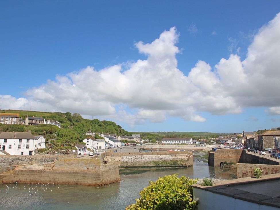 A view of the harbor with houses and water at Kernyk Rinsey near Porthleven