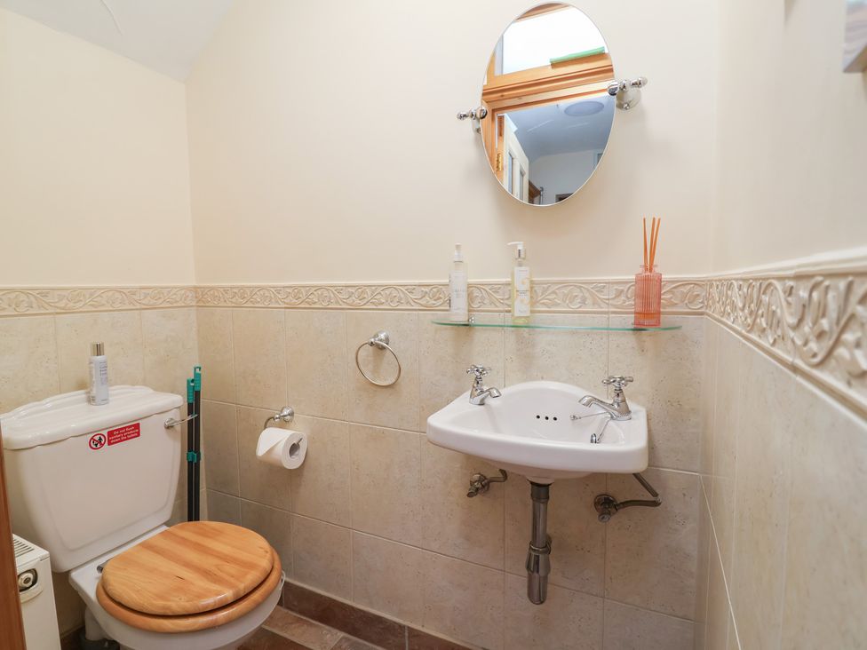 A bathroom with a sink and toilet at Ash Farm Cottage Lixwm near Caerwys