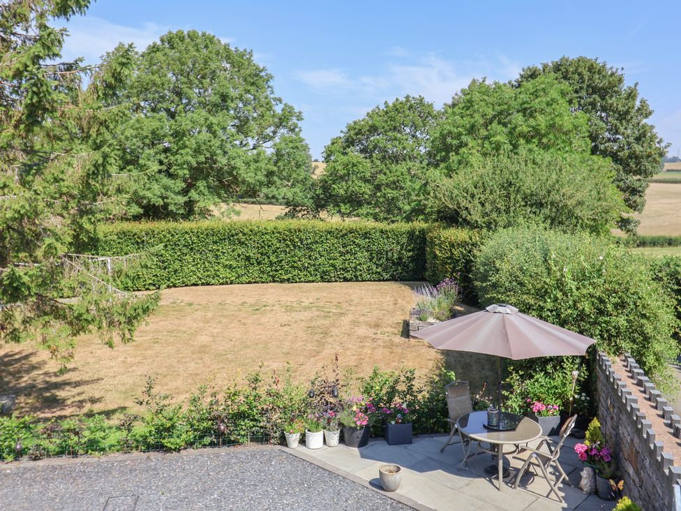 A garden with patio furniture and plants at Ash Farm Cottage in Lixwm near Caerwys