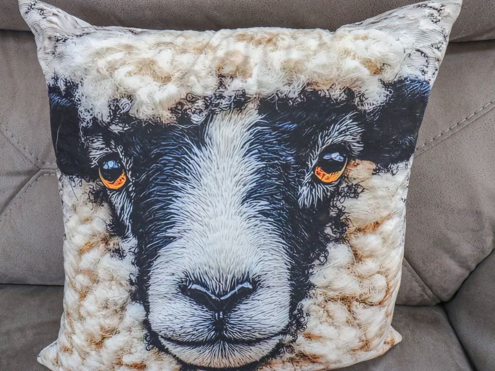 A cushion with a sheep face design