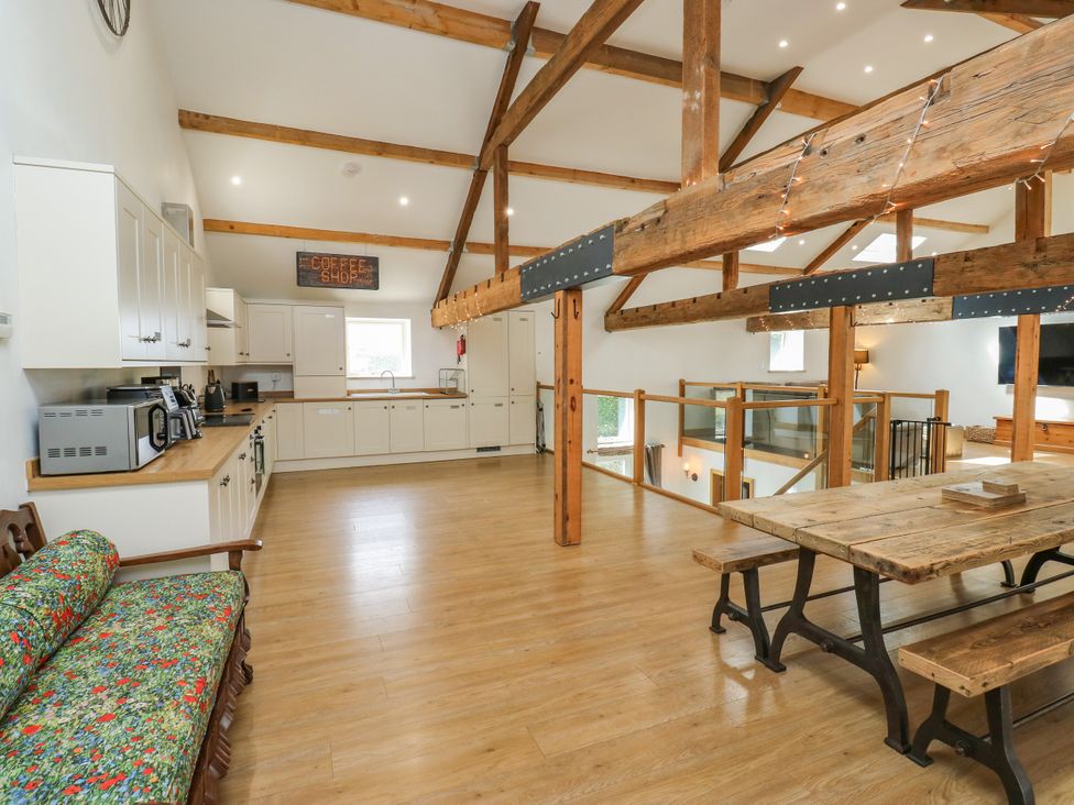 A kitchen with a table and counter in Upper House Barn (Saddleworth) Delph