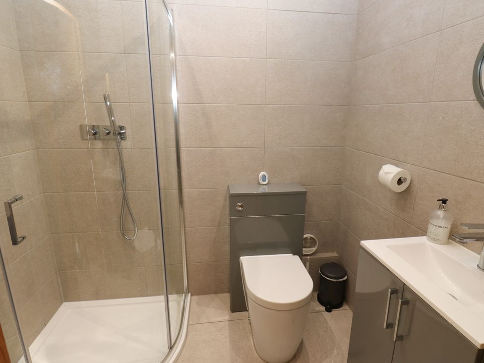 A bathroom featuring a shower and a toilet at Upper House Barn (Saddleworth) Delph