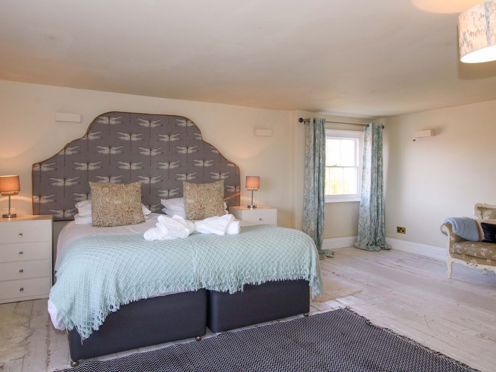 A bedroom with a bed and lamp at Hilltop House in Tenbury Wells