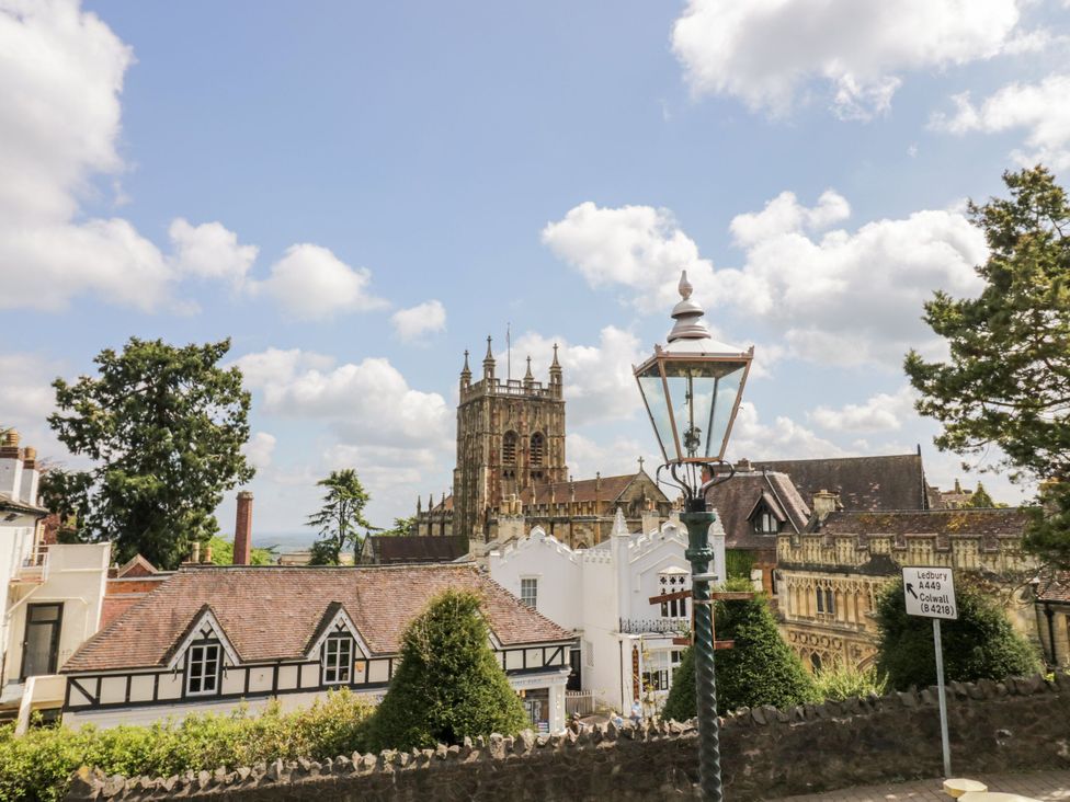 A view of a church with a lamp post and buildings in the foreground at Hilltop House Tenbury Wells