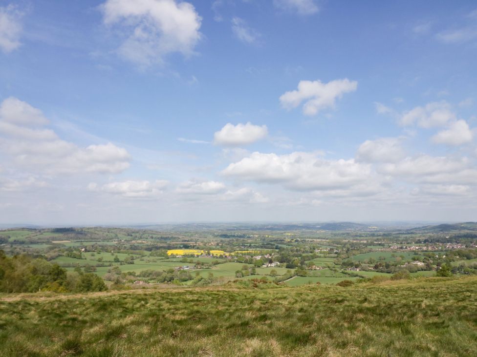 A panoramic view of fields and hills under a cloudy sky at Hilltop House in Tenbury Wells