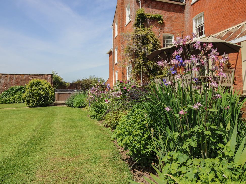 Garden with flowers and grass at Hilltop House in Tenbury Wells