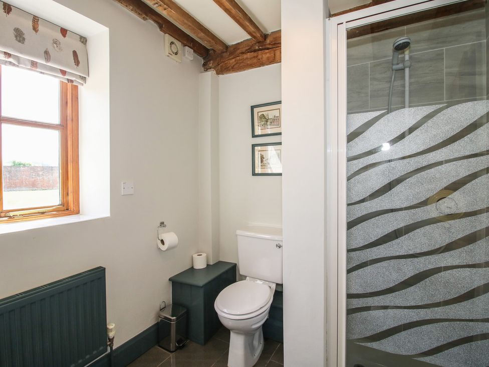 A bathroom with a toilet and shower at The Chestnuts in Tenbury Wells