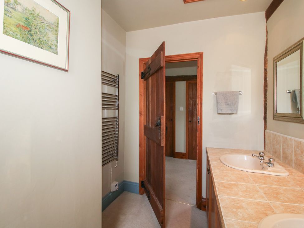 A bathroom with a sink and mirror at The Chestnuts in Tenbury Wells