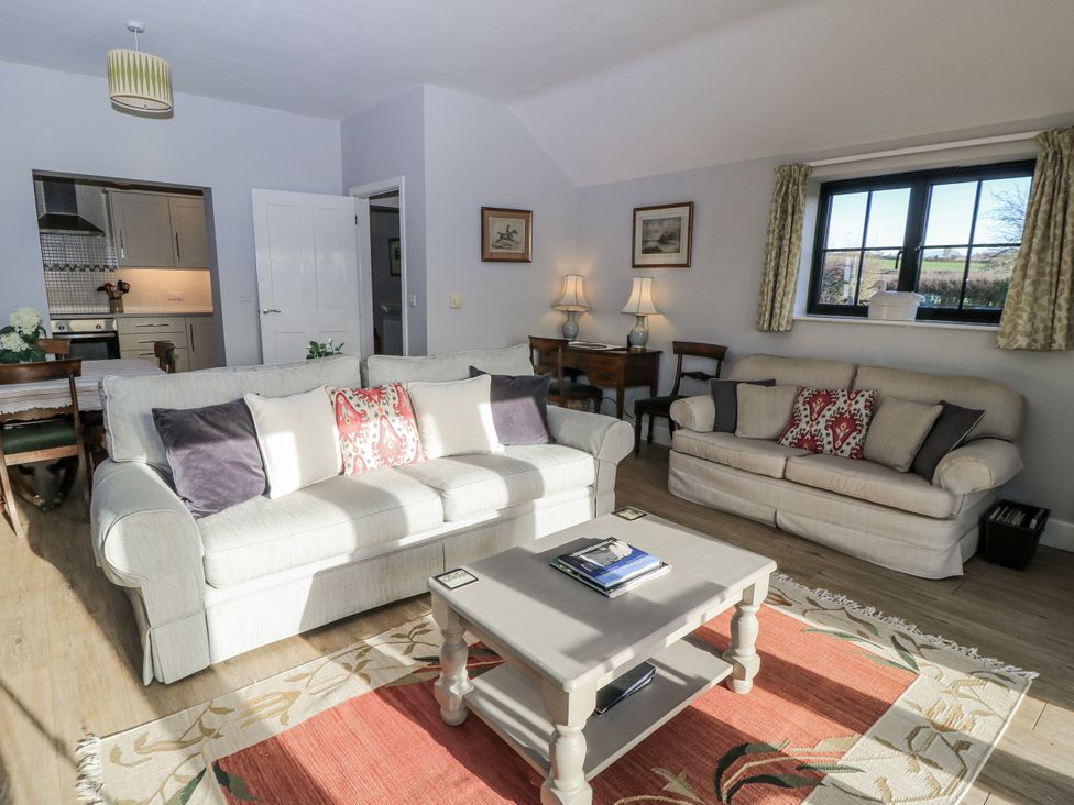 A living room with sofas and a coffee table at Keepers Cottage in West Knoyle