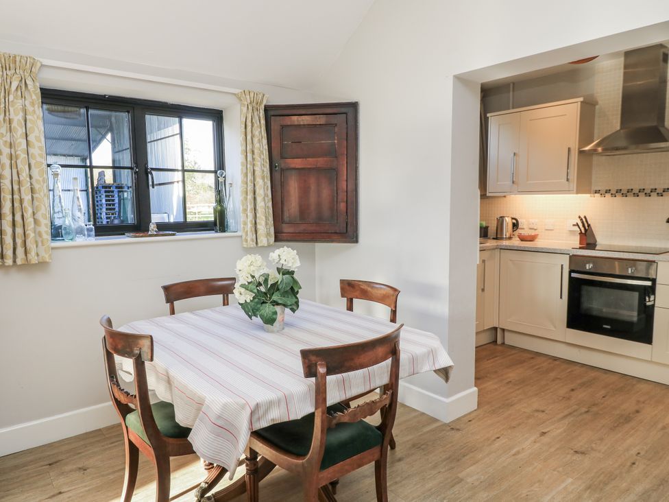 A kitchen with a table and chairs at Keepers Cottage in West Knoyle