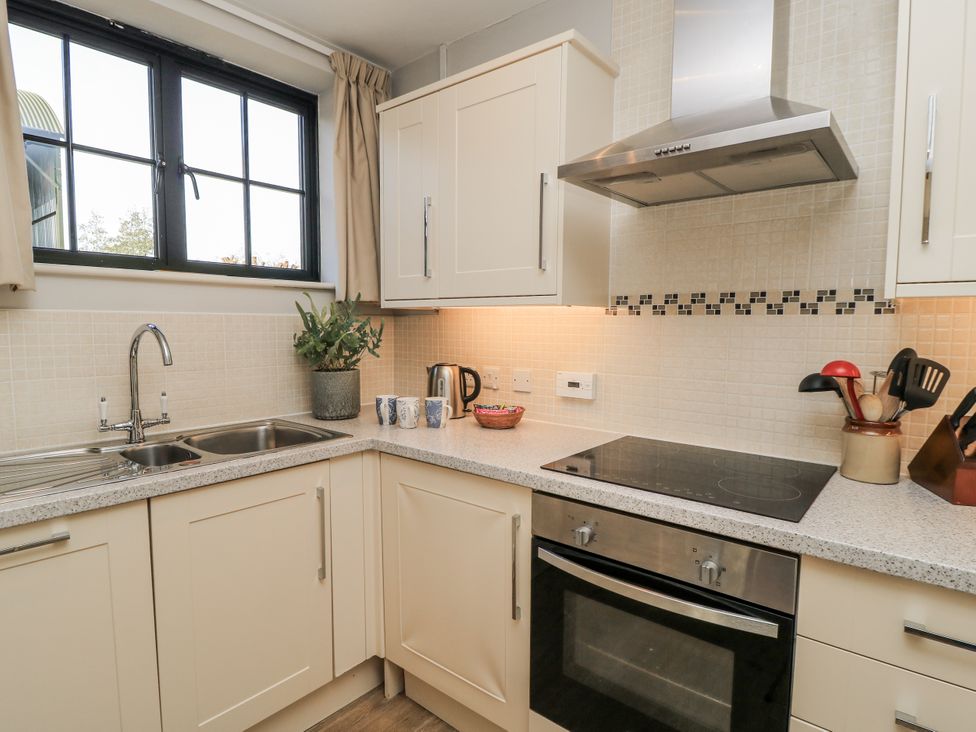 A kitchen with sink and stove at Keepers Cottage in West Knoyle