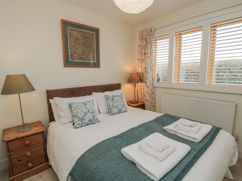 A bedroom with a bed and bedside table at Keepers Cottage in West Knoyle