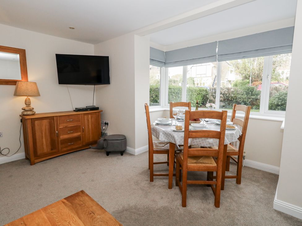 A dining room with a table and chairs at Mayflower in Swanage