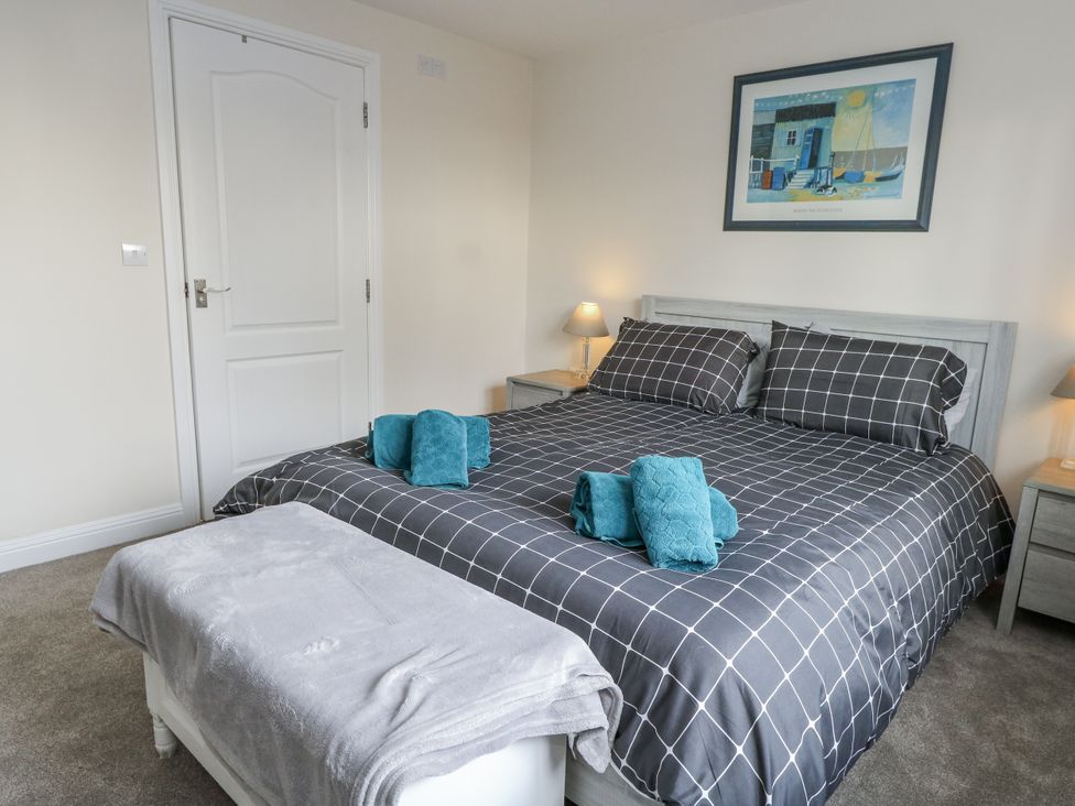 A bedroom with a double bed and bedside tables at Mayflower in Swanage