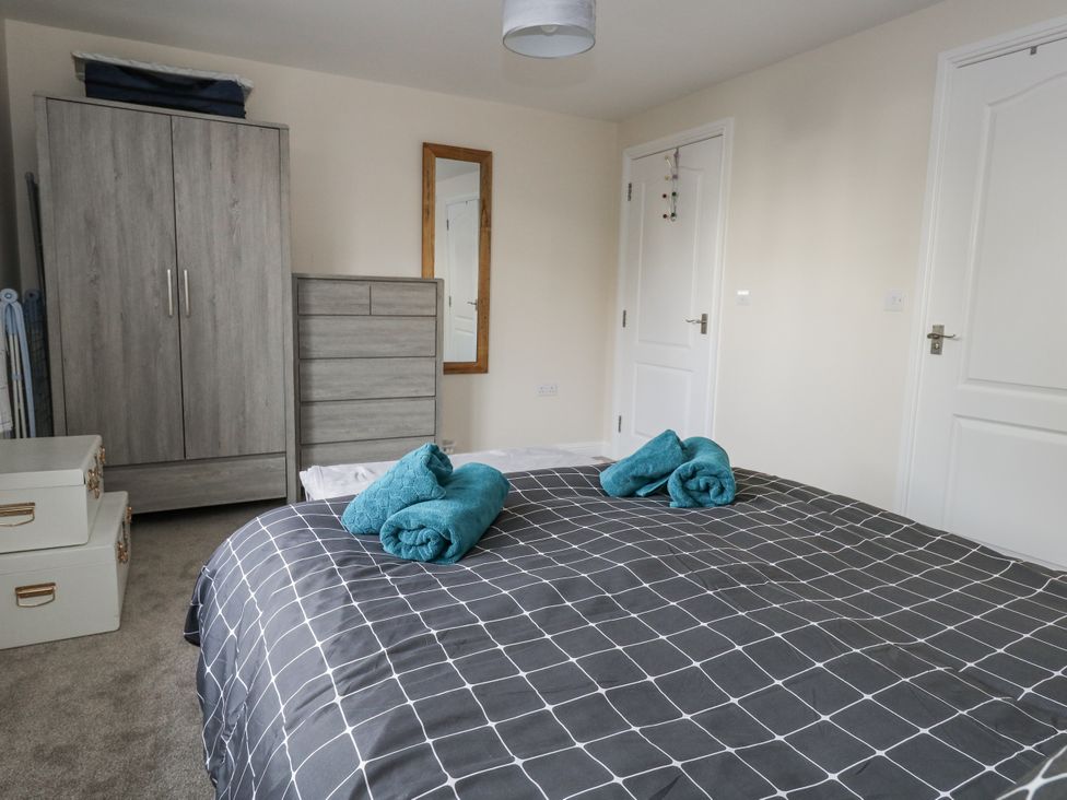 A bedroom with a bed and storage furniture at Mayflower in Swanage