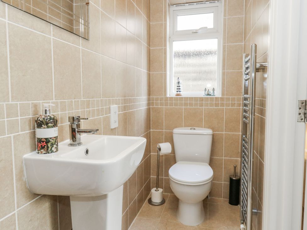 A bathroom with a sink and toilet at Mayflower in Swanage