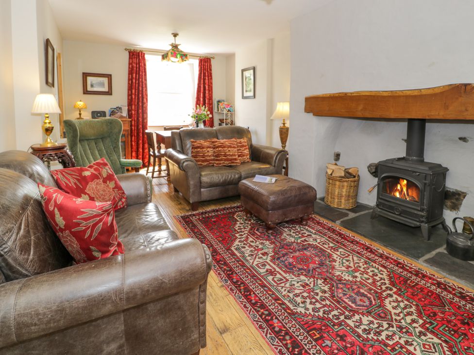 A living room with a sofa and fireplace at Sygun View in Beddgelert