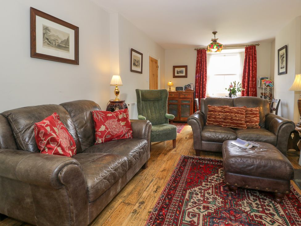 A living room with a sofa and armchair at Sygun View in Beddgelert