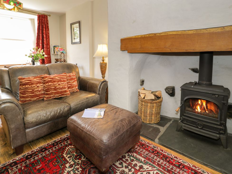 A living room with a sofa and fireplace at Sygun View in Beddgelert