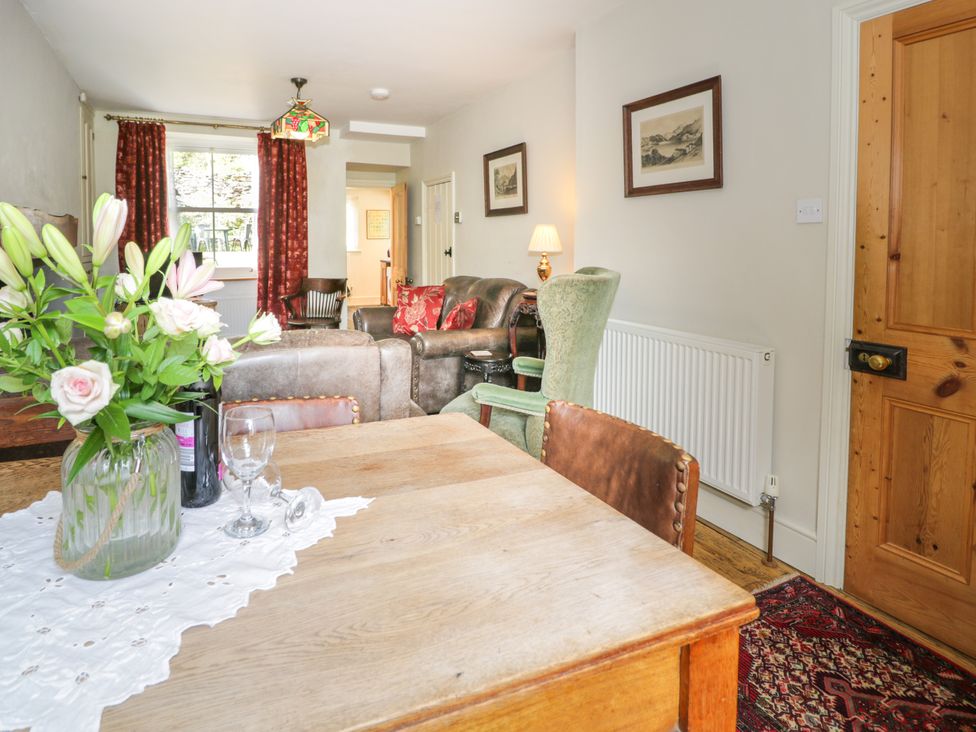 A living room with a table and flowers at Sygun View in Beddgelert