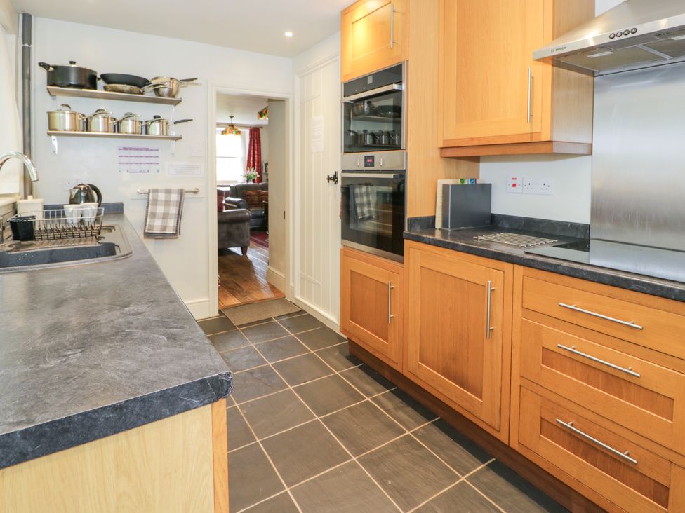 A kitchen with a sink, oven, and countertop at Sygun View in Beddgelert