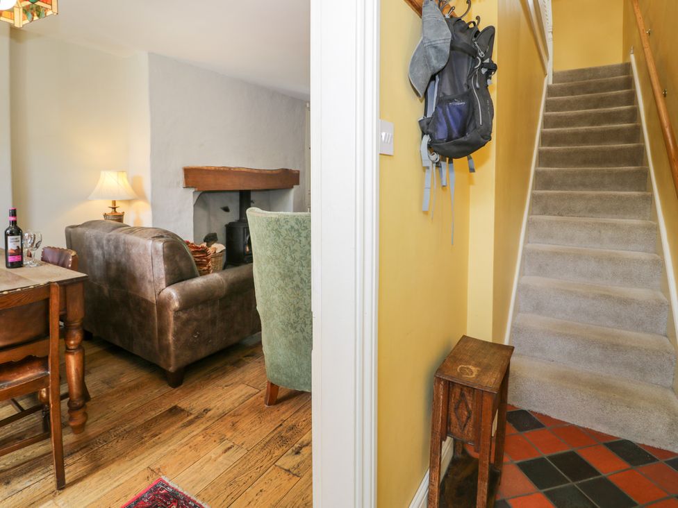 A living room with a sofa and table near stairs at Sygun View in Beddgelert