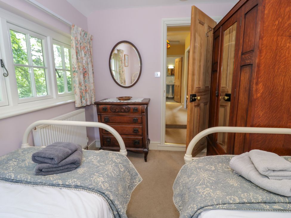 A bedroom with two beds and a chest of drawers at Sygun View in Beddgelert