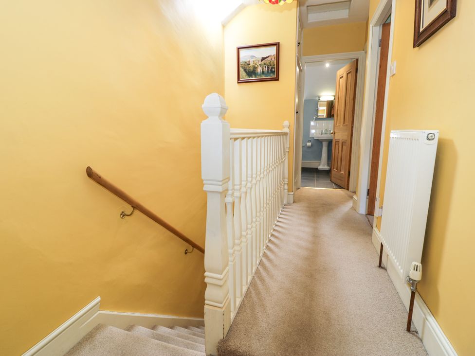 A hallway with stairs and a door at Sygun View in Beddgelert
