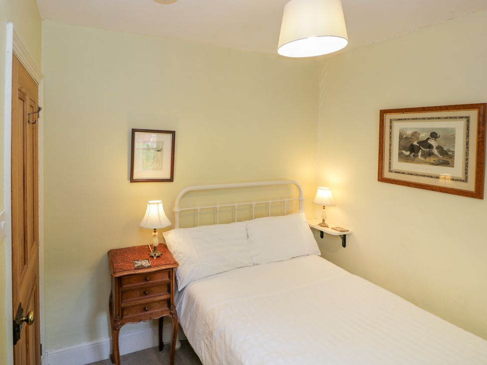 A bedroom with a bed and nightstand at Sygun View in Beddgelert
