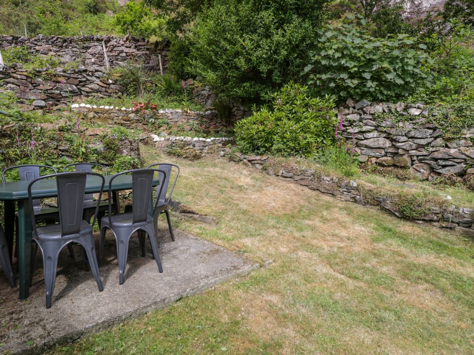 A table and chairs in a garden at Sygun View Beddgelert