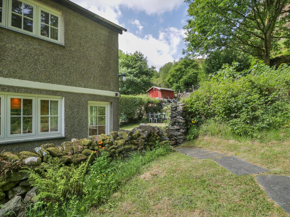 A garden with a house and a red shed at Sygun View in Beddgelert