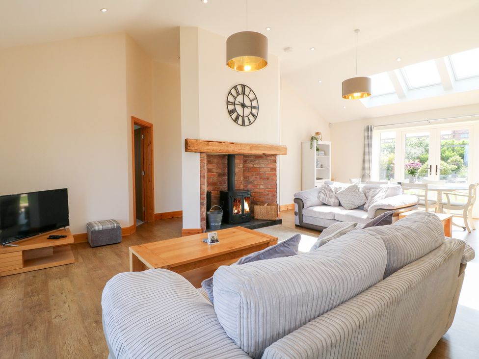 A living room with a sofa and fireplace at Mandarin Cottage in Melton Mowbray