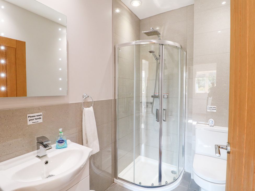 A bathroom with a shower and sink at Mandarin Cottage in Melton Mowbray
