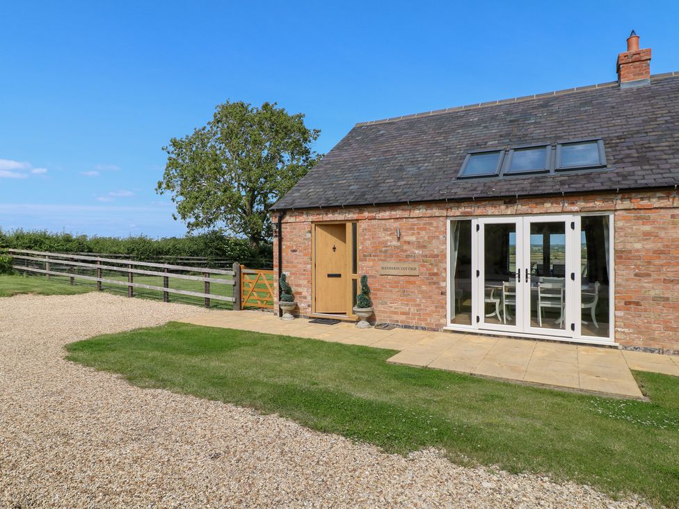 An outdoor view of a brick house with garden at Mandarin Cottage in Melton Mowbray