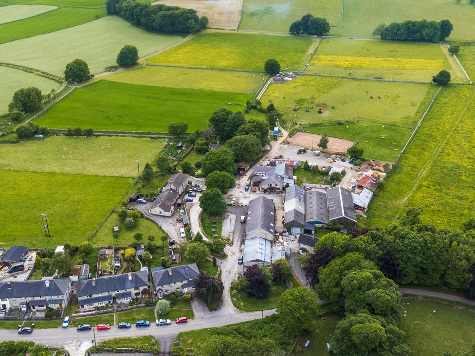 An aerial view of a farm with fields and buildings at The Loft in Buxton